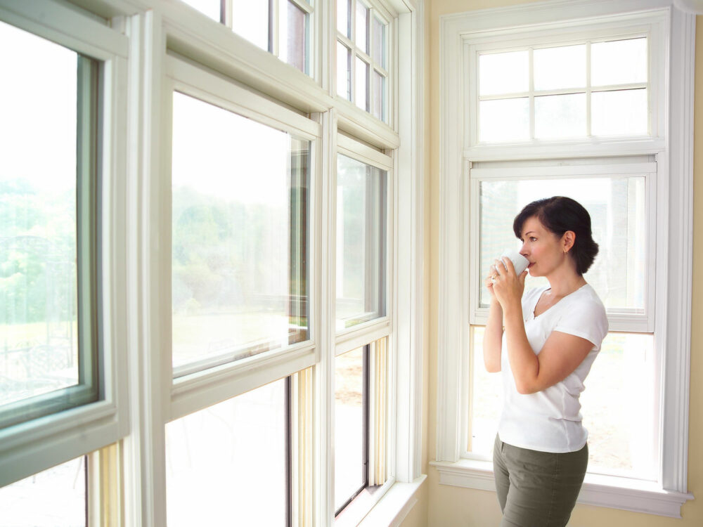A,Woman,Sips,Coffee,And,Looks,Out,The,Window.